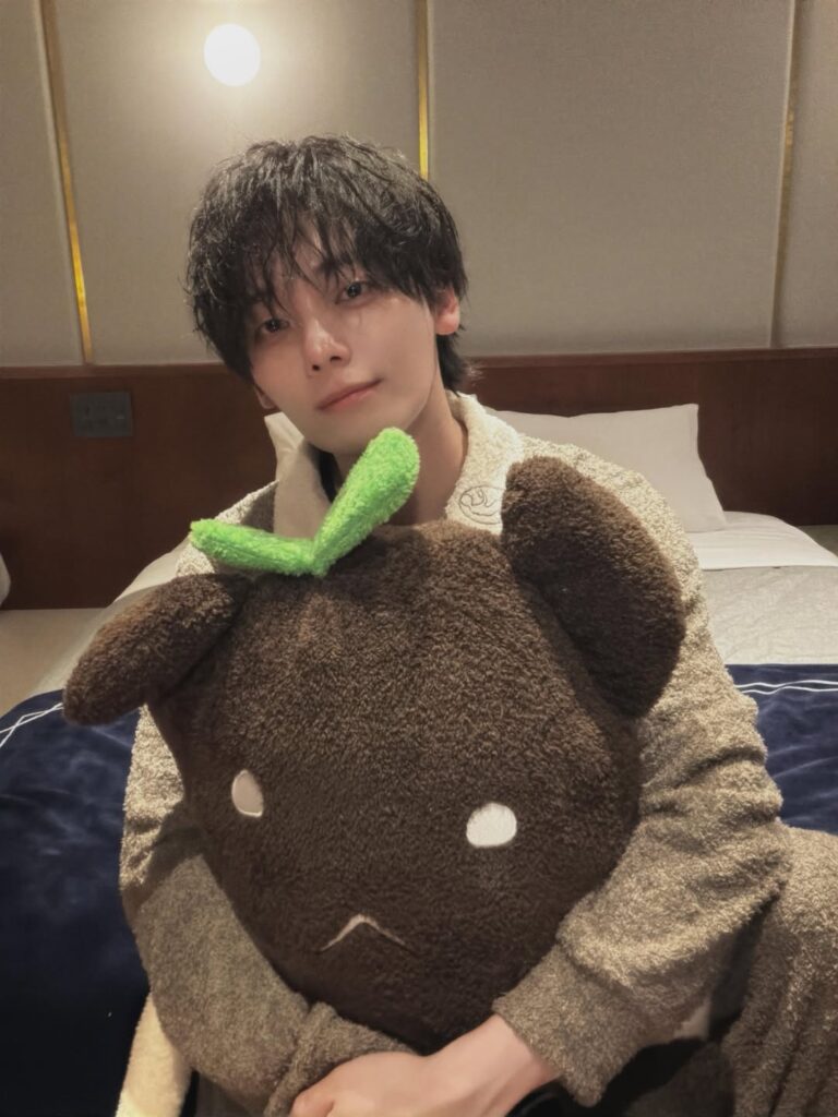 ホテルの客室で大きなぬいぐるみを抱えてほほ笑むみやかわくん